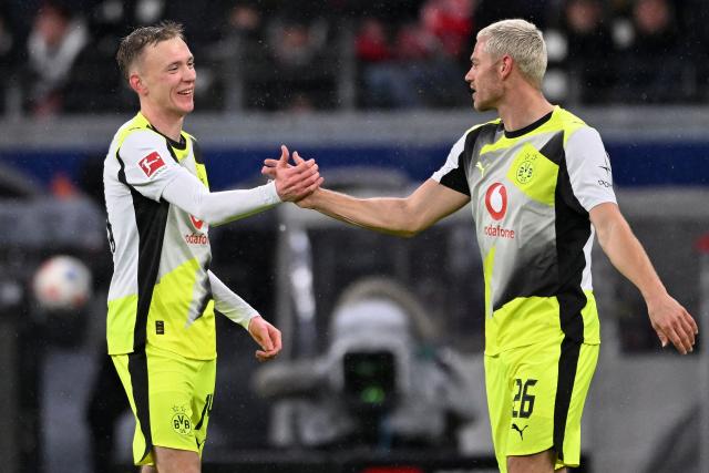 Dortmund's German forward #14 Maximilian Beier (L) celebrates scoring the opening goal with his teammate Dortmund's Norwegian defender #26 Julian Ryerson during the German first division Bundesliga football match between Eintracht Frankfurt and BVB Borussia Dortmund in Frankfurt am Main, western Germany, on January 9, 2026. (Photo by Kirill KUDRYAVTSEV / AFP) / DFL REGULATIONS PROHIBIT ANY USE OF PHOTOGRAPHS AS IMAGE SEQUENCES AND/OR QUASI-VIDEO