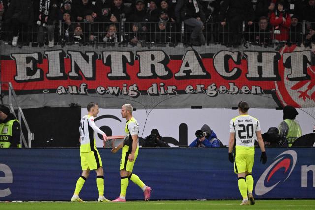 Dortmund's German forward #14 Maximilian Beier (L) celebrates scoring the opening goal with his teammates during the German first division Bundesliga football match between Eintracht Frankfurt and BVB Borussia Dortmund in Frankfurt am Main, western Germany, on January 9, 2026. (Photo by Kirill KUDRYAVTSEV / AFP) / DFL REGULATIONS PROHIBIT ANY USE OF PHOTOGRAPHS AS IMAGE SEQUENCES AND/OR QUASI-VIDEO