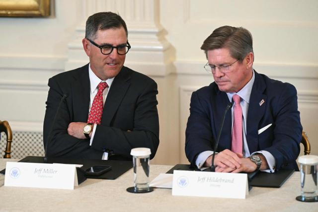 (L-R) CEO and President of Haliburton Jeff Miller and Hilcorp CEO Jeffery Hildebrand, looks on during a meeting with US oil companies executives in the East Room of the White House in Washington, DC on January 9, 2026. President Trump is aiming to convince oil executives to support his plans in Venezuela, a country whose energy resources he says he expects to control for years to come. US forces seized Venezuelan president Nicolas Maduro in a sweeping military operation on January 3, with Trump making no secret that control of Venezuela's oil was at the heart of his actions. (Photo by SAUL LOEB / AFP)