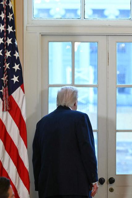 US President Donald Trump looks through a window to observe construction work on his new ballroom prior to a meeting with US oil company executives in the East Room of the White House in Washington, DC, on January 9, 2026. President Trump is aiming to convince oil executives to support his plans in Venezuela, a country whose energy resources he says he expects to control for years to come. US forces seized Venezuelan president Nicolas Maduro in a sweeping military operation on January 3, with Trump making no secret that control of Venezuela's oil was at the heart of his actions. (Photo by SAUL LOEB / AFP)