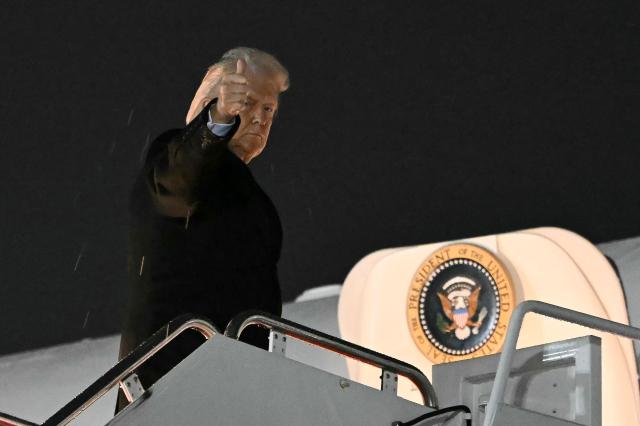 US President Donald Trump boards Air Force One at Joint Base Andrews, Maryland on January 9, 2026. (Photo by ANDREW CABALLERO-REYNOLDS / AFP)