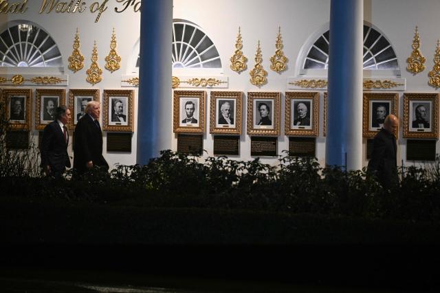 US President Donald Trump and US secretary of Interior Doug Burgum (L)
walk on the Colonnade prior departure from the South Lawn of the White House in Washington, DC, on January 9, 2026. (Photo by Brendan SMIALOWSKI / AFP)
