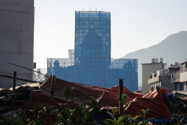 The Yayang church is seen covered in scaffolding in Yayang township, Wenzhou city, in eastern China's Zhejiang province on January 9, 2026. A church in east China was scaffolded and had its cross removed, AFP reporters saw January 9, with residents and rights groups saying multiple members had been arrested as a national crackdown on unofficial Christian organisations grows. (Photo by Rebecca BAILEY / AFP)