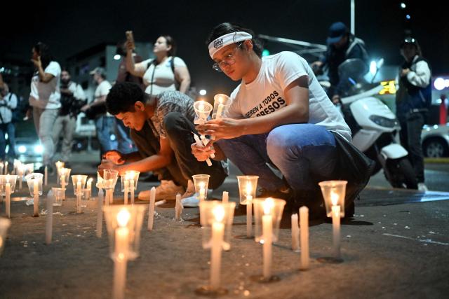 Relatives of political prisoners light candles in a vigil in demand of the release of their loved ones, near the notorious El Helicoide -a facility and prison owned by the Venezuelan government and used for both regular and political prisoners of the Bolivarian National Intelligence Service (SEBIN)- in Caracas on January 9, 2026. Venezuela began releasing a "large number" of political prisoners, including several foreigners, in a move praised by US President Donald Trump on January 9 as a step toward cooperation after the ouster of ruler Nicolas Maduro. (Photo by Juan BARRETO / AFP)