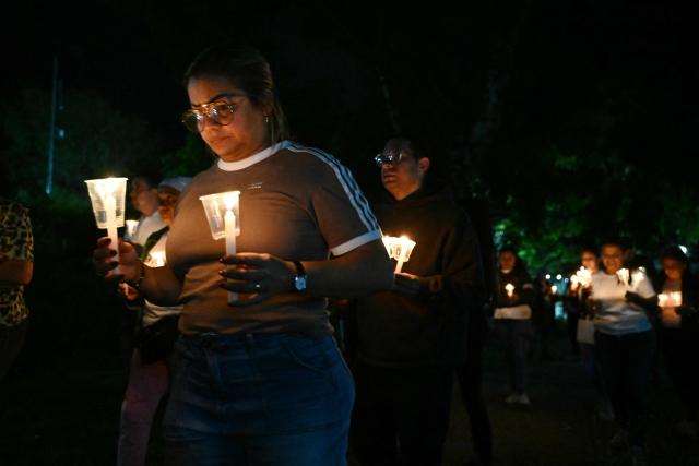 Relatives of political prisoners light candles during a vigil in demand of the release of their loved ones outside of El Rodeo I prison in Guatire, Miranda State, some 30 kilometers east of Caracas on January 9, 2026. Venezuela on January 8 began releasing a "large number" of political prisoners, including several foreigners, in a move praised by US President Donald Trump as a step toward cooperation after the ouster of ruler Nicolas Maduro. (Photo by RONALDO SCHEMIDT / AFP)