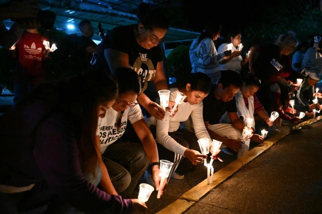 Relatives of political prisoners light candles during a vigil in demand of the release of their loved ones outside of El Rodeo I prison in Guatire, Miranda State, some 30 kilometers east of Caracas on January 9, 2026. Venezuela on January 8 began releasing a "large number" of political prisoners, including several foreigners, in a move praised by US President Donald Trump as a step toward cooperation after the ouster of ruler Nicolas Maduro. (Photo by RONALDO SCHEMIDT / AFP)