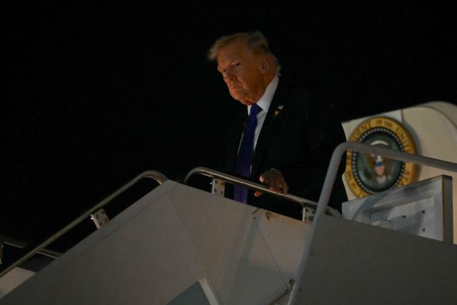 US President Donald Trump steps off Air Force One upon arrival at Palm Beach International Airport in West Palm Beach, Florida on January 9, 2026. President Trump is in Florida to spend the week-end at his Mar-a-Lago estate. (Photo by ANDREW CABALLERO-REYNOLDS / AFP)