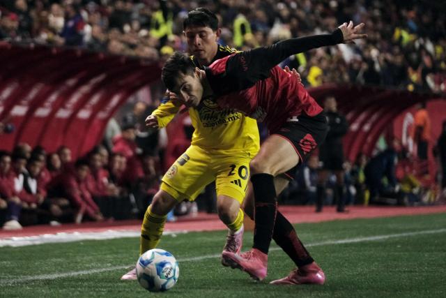 America's midfielder #20 Alexis Gutierrez and Tijuana's Spanish defender #04 Unai Bilbao fight for the ball during the Liga MX Clausura tournament football match between Tijuana and America at Caliente Stadium in Tijuana, Baja California, Mexico on January 9, 2026. (Photo by Guillermo Arias / AFP)