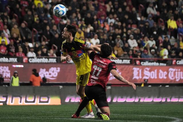 America's Spanish midfielder #08 Alvaro Fidalgo and Tijuana's Uruguayan midfielder #22 Ignacio Riverofight for the ball during the Liga MX Clausura tournament football match between Tijuana and America at Caliente Stadium in Tijuana, Baja California, Mexico on January 9, 2026. (Photo by Guillermo Arias / AFP)