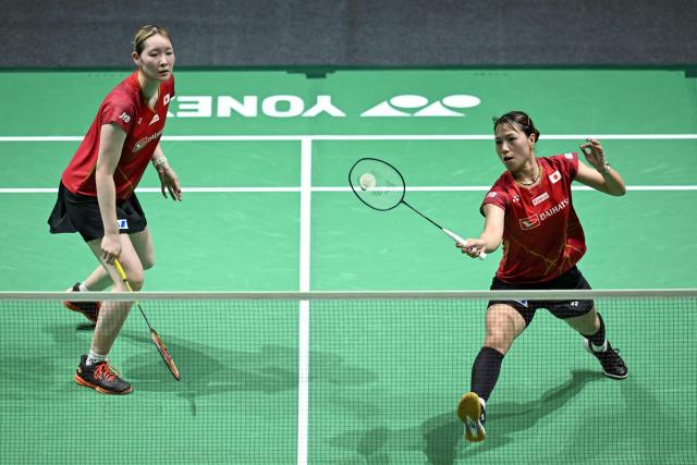 Japan's Yuki Fukushima (R) and Mayu Matsumoto (L) play a point during their women's doubles semi-final match against South Korea’s Baek Ha-na and Lee So-hee at the Malaysia Open badminton tournament in Kuala Lumpur on January 10, 2026. (Photo by MOHD RASFAN / AFP)