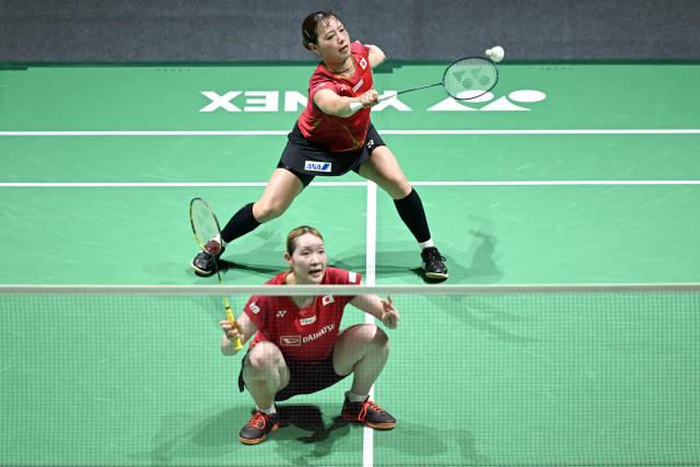 Japan's Yuki Fukushima (back) and Mayu Matsumoto (front) play a point during their women's doubles semi-final match against South Korea’s Baek Ha-na and Lee So-hee at the Malaysia Open badminton tournament in Kuala Lumpur on January 10, 2026. (Photo by MOHD RASFAN / AFP)