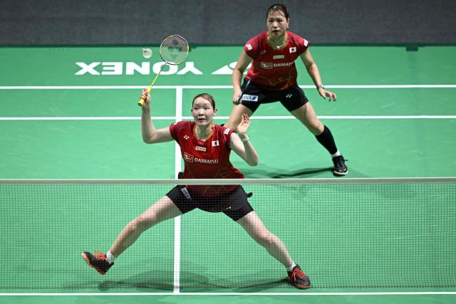 Japan's Yuki Fukushima (back) and Mayu Matsumoto (front) play a point during their women's doubles semi-final match against South Korea’s Baek Ha-na and Lee So-hee at the Malaysia Open badminton tournament in Kuala Lumpur on January 10, 2026. (Photo by MOHD RASFAN / AFP)
