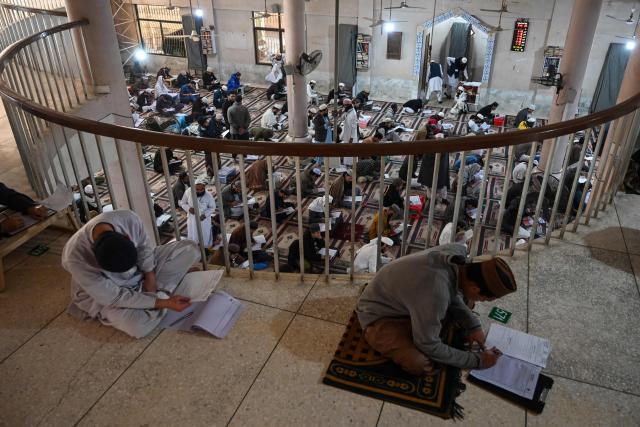 Students appear for their annual examination at the Islamic Jamia Binoria Aalamia seminary in Karachi on January 10, 2026. (Photo by Rizwan TABASSUM / AFP)