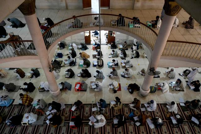 Students appear for their annual examination at the Islamic Jamia Binoria Aalamia seminary in Karachi on January 10, 2026. (Photo by Rizwan TABASSUM / AFP)