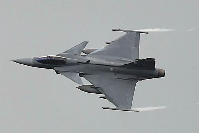 A Royal Thai Air Force JAS 39 Gripen fighter jet maneuvers during a show at Chulaporn military camp opened to the public for Thailand's National Children's Day in the southern province of Narathiwat on January 10, 2026. (Photo by Madaree TOHLALA / AFP)