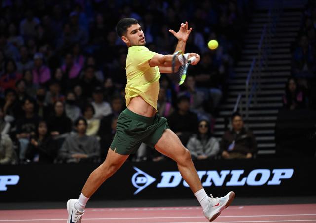 Spain's Carlos Alcaraz hits a return to Italy's Jannik Sinner during their exhibition tennis match at Inspire Arena in Incheon on January 10, 2026. (Photo by Jung Yeon-je / AFP)