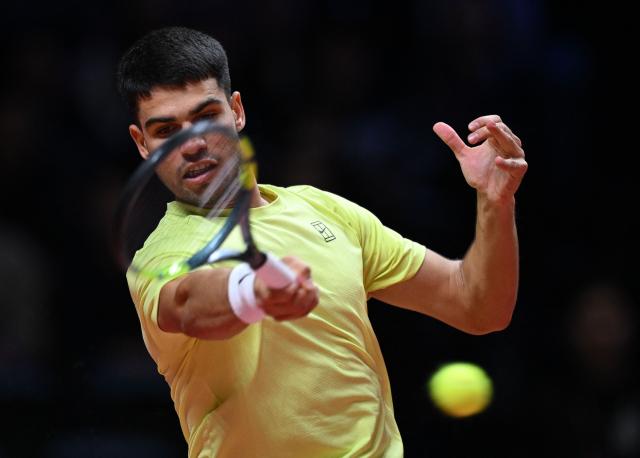 Spain's Carlos Alcaraz hits a return to Italy's Jannik Sinner during their exhibition tennis match at Inspire Arena in Incheon on January 10, 2026. (Photo by Jung Yeon-je / AFP)