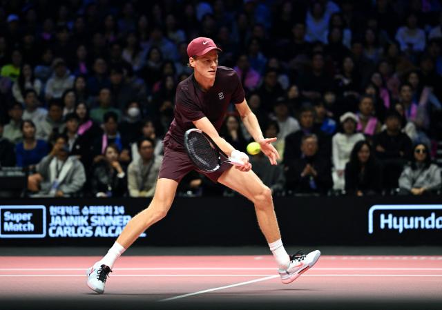 Italy's Jannik Sinner hits a return to Spain's Carlos Alcaraz during their exhibition tennis match at Inspire Arena in Incheon on January 10, 2026. (Photo by Jung Yeon-je / AFP)
