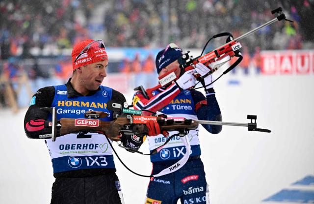 Germany's Philipp Nawrath (L) and Norway's Johannes Dale-Skjevdal compete at the shooting range during the men's 12,5km pursuit event of the IBU Biathlon World Cup in Oberhof, eastern Germany on January 10, 2026. (Photo by Tobias SCHWARZ / AFP)