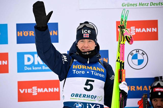 Second placed Norway's Martin Uldal celebrates on the podium after the men's 12,5km pursuit event of the IBU Biathlon World Cup in Oberhof, eastern Germany on January 10, 2026. (Photo by Tobias SCHWARZ / AFP)