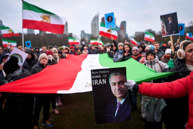 Protesters hold placards and Iranian flags during a demonstration to support mass rallies denouncing the Islamic republic in Iran at Malieveld square in The Hague on January 10, 2026. The two weeks of protests have posed one of the biggest challenges to the theocratic authorities who have ruled Iran since the 1979 Islamic revolution, although supreme leader has expressed defiance and blamed the US. (Photo by Phil Nijhuis / ANP / AFP) / Netherlands OUT