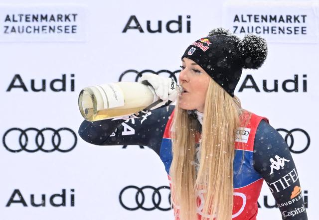 US' Lindsey Vonn celebrates with sparkling wine on the podium after winning the Women's Downhill event of the FIS Alpine Ski World Cup in Altenmarkt Zauchensee, Austria, on January 10, 2026. (Photo by BARBARA GINDL / APA / AFP) / Austria OUT