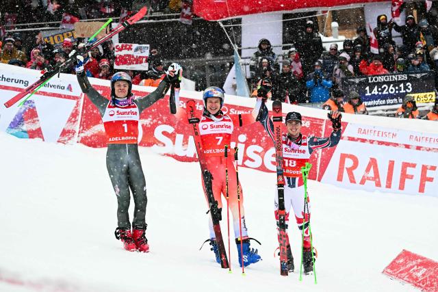 (From L) Second-placed Brazil's Lucas Pinheiro Braathen, first-placed Switzerland's Marco Odermatt and third-placed France's Leo Anguenot celebrate after the second run of the Men's Giant Slalom, part of the FIS Alpine Ski World Cup 2025-2026 in Adelboden, soutwestern Switzerland on January 10, 2026. (Photo by Fabrice COFFRINI / AFP)
