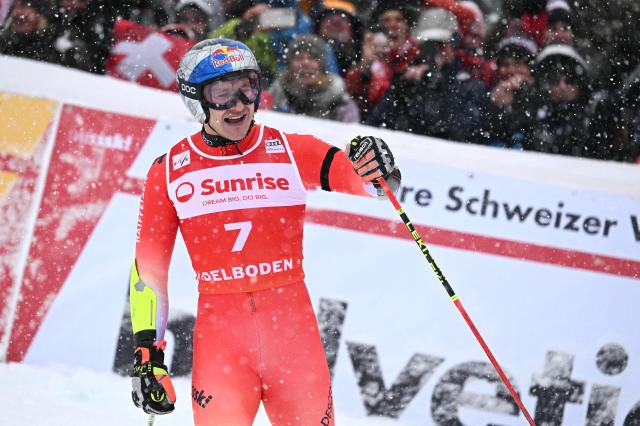 Switzerland's Marco Odermatt celebrates as he crosses the finish line to win the second run of the Men's Giant Slalom, part of the FIS Alpine Ski World Cup 2025-2026 in Adelboden, soutwestern Switzerland on January 10, 2026. (Photo by Fabrice COFFRINI / AFP)