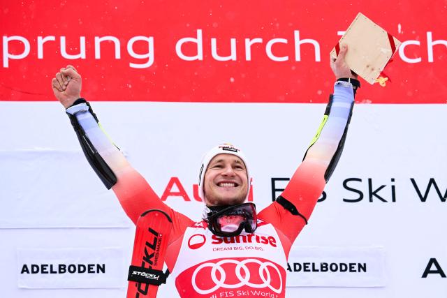 Switzerland's Marco Odermatt celebrates on the podium after winning the Men's Giant Slalom, part of the FIS Alpine Ski World Cup 2025-2026 in Adelboden, soutwestern Switzerland on January 10, 2026. (Photo by Fabrice COFFRINI / AFP)