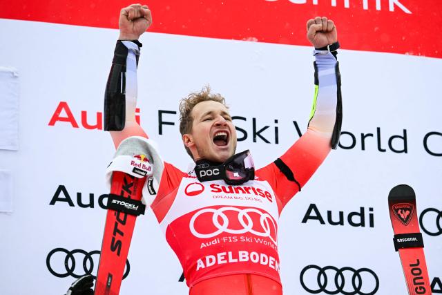 Switzerland's Marco Odermatt celebrates on the podium after winning the Men's Giant Slalom, part of the FIS Alpine Ski World Cup 2025-2026 in Adelboden, soutwestern Switzerland on January 10, 2026. (Photo by Fabrice COFFRINI / AFP)