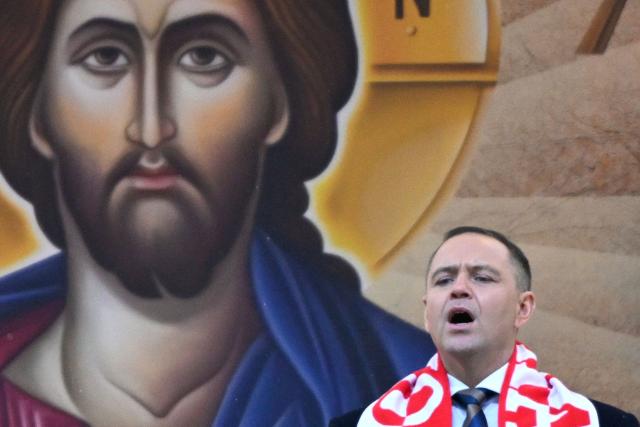 Poland's President Karol Nawrocki sings the "Te Deum" hymn following a holy mass during the annual pilgrimage of Polish football fans at the Jasna Gora Monastery in Czestochowa, Poland, on January 10, 2026. (Photo by Sergei GAPON / AFP)