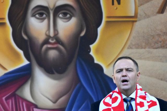 Poland's President Karol Nawrocki sings the "Te Deum" hymn following a holy mass during the annual pilgrimage of Polish football fans at the Jasna Gora Monastery in Czestochowa, Poland, on January 10, 2026. (Photo by Sergei GAPON / AFP)