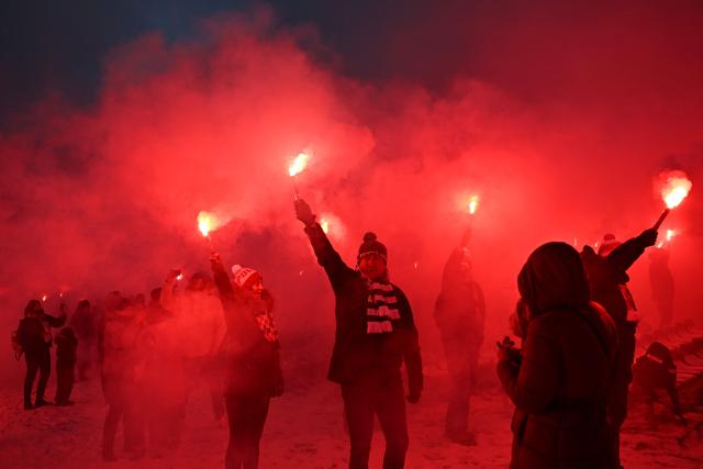 Polish football fans light flares following a holy mass during their annual pilgrimage at the Jasna Gora Monastery in Czestochowa on January 10, 2026. Polish football fans put aside their rivalries every year and gather at Poland’s holiest Catholic shrine the Jasna Gora Monastery in Czestochowa. (Photo by Sergei GAPON / AFP)