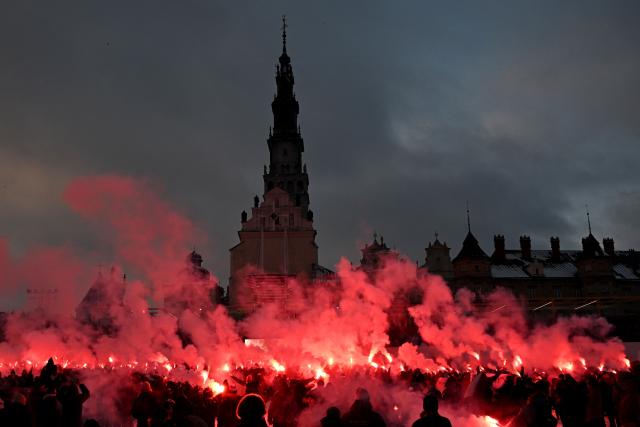 Polish football fans light flares following a holy mass during their annual pilgrimage at the Jasna Gora Monastery in Czestochowa on January 10, 2026. Polish football fans put aside their rivalries every year and gather at Poland’s holiest Catholic shrine the Jasna Gora Monastery in Czestochowa. (Photo by Sergei GAPON / AFP)