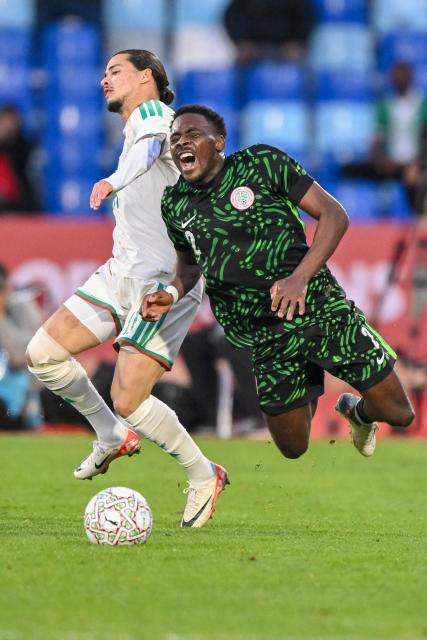 Algeria's forward #11 Anis Hadj Moussa and Nigeria's defender #02 Bright Osayi-Samuel vie during the Africa Cup of Nations (CAN) quarter-final football match between Algeria and Nigeria at the Grand stadium in Marrakesh on January 10, 2026. (Photo by SEBASTIEN BOZON / AFP)