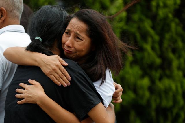 Women hug and encourage each other while waiting for news on the release of prisoners, outside El Rodeo I prison in Guatire, Miranda State, some 30 kilometers east of Caracas on January 10, 2026. Venezuela on January 8 began releasing a "large number" of political prisoners, including several foreigners, in a move praised by US President Donald Trump as a step toward cooperation after the ouster of ruler Nicolas Maduro. (Photo by Pedro MATTEY / AFP)