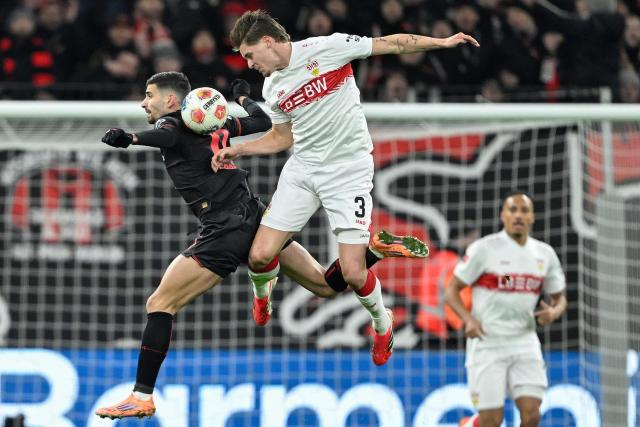 Bayer Leverkusen's French forward #11 Martin Terrier (L) and Stuttgart's Dutch defender #03 Ramon Hendriks vie for the ball during the German first division Bundesliga football match between Bayer 04 Leverkusen and 1 VfB Stuttgart in Leverkusen, western Germany, on January 10, 2026. (Photo by INA FASSBENDER / AFP) / DFL REGULATIONS PROHIBIT ANY USE OF PHOTOGRAPHS AS IMAGE SEQUENCES AND/OR QUASI-VIDEO