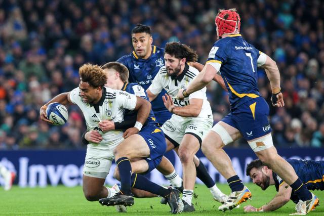 La Rochelle's Fijian centre Simeli Daunivucu (L) is tackled during the European Champions Cup Pool 3 rugby union match between Leinster and Stade Rochelais at Aviva Stadium in Dublin, Ireland on January 10, 2026. (Photo by Paul Faith / AFP)