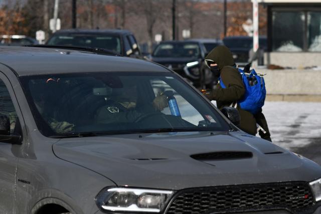 A anti-ICE protester shout at ICE agents as they exit the Bishop Henry Whipple Federal Building parking lot in during demonstrations sparked by the fatal shooting of a Renee Good by an ICE officer, Minnesota, on January 10, 2026. A US Immigration and Customs Enforcement (ICE) agent shot and killed an American woman on the streets of Minneapolis January 7, leading to huge protests and outrage from local leaders who rejected White House claims she was a domestic terrorist. The woman, identified in local media as 37-year-old Renee Nicole Good, was hit at point blank range as she apparently tried to drive away from agents who were crowding around her car, which they said was blocking their way. (Photo by Octavio JONES / AFP)