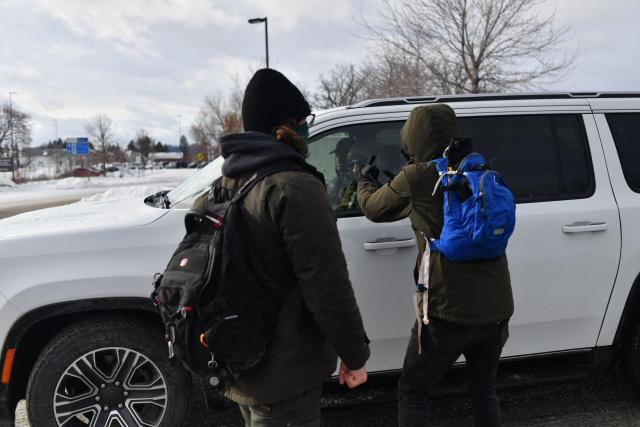 A anti-ICE protester shout at ICE agents as they exit the Bishop Henry Whipple Federal Building parking lot in during demonstrations sparked by the fatal shooting of a Renee Good by an ICE officer, Minnesota, on January 10, 2026. A US Immigration and Customs Enforcement (ICE) agent shot and killed an American woman on the streets of Minneapolis January 7, leading to huge protests and outrage from local leaders who rejected White House claims she was a domestic terrorist. The woman, identified in local media as 37-year-old Renee Nicole Good, was hit at point blank range as she apparently tried to drive away from agents who were crowding around her car, which they said was blocking their way. (Photo by Octavio JONES / AFP)