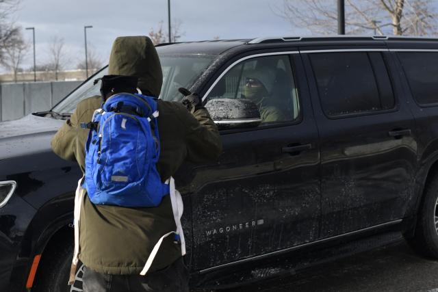 A anti-ICE protester shout at ICE agents as they exit the Bishop Henry Whipple Federal Building parking lot in during demonstrations sparked by the fatal shooting of a Renee Good by an ICE officer, Minnesota, on January 10, 2026. A US Immigration and Customs Enforcement (ICE) agent shot and killed an American woman on the streets of Minneapolis January 7, leading to huge protests and outrage from local leaders who rejected White House claims she was a domestic terrorist. The woman, identified in local media as 37-year-old Renee Nicole Good, was hit at point blank range as she apparently tried to drive away from agents who were crowding around her car, which they said was blocking their way. (Photo by Octavio JONES / AFP)