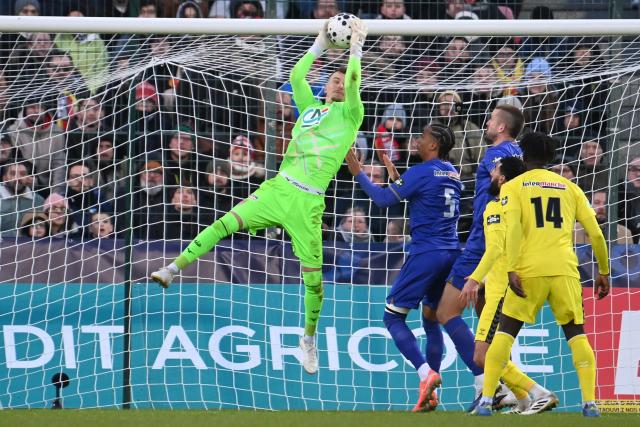 Monaco's Swiss goalkeeper #01 Philipp Francois Koehn jumps to make a save during the French Cup round of 32 football match between US Orleans and AS Monaco at the Stade de la Source in Orleans, central France on January 10, 2026. (Photo by JEAN-FRANCOIS MONIER / AFP)