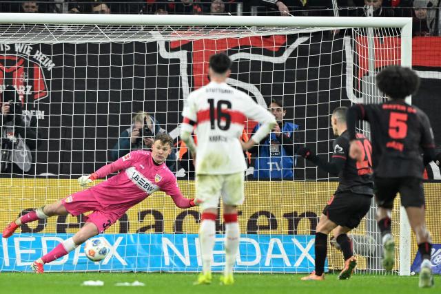 Bayer Leverkusen's Spanish defender #20 Alejandro Grimaldo (2nd R) scores the 1-4 goal from the penalty spot past Stuttgart's German goalkeeper #33 Alexander Nuebel during the German first division Bundesliga football match between Bayer 04 Leverkusen and 1 VfB Stuttgart in Leverkusen, western Germany, on January 10, 2026. (Photo by INA FASSBENDER / AFP) / DFL REGULATIONS PROHIBIT ANY USE OF PHOTOGRAPHS AS IMAGE SEQUENCES AND/OR QUASI-VIDEO