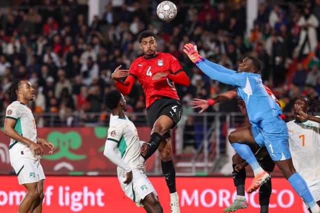 Egypt's defender #04 Hossam Abdelmaguid heads the ball in front of Ivory Coast's goalkeeper #01 Yahia Fofana during the Africa Cup of Nations (CAN) quarter-final football match between Egypt and Ivory Coast at the Grand stadium in Agadir on January 10, 2026. (Photo by FRANCK FIFE / AFP)
