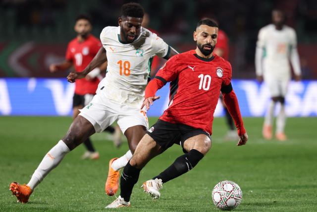 Ivory Coast's midfielder #18 Ibrahim Sangare and Egypt's forward #10 Mohamed Salah vie during the Africa Cup of Nations (CAN) quarter-final football match between Egypt and Ivory Coast at the Grand stadium in Agadir on January 10, 2026. (Photo by FRANCK FIFE / AFP)