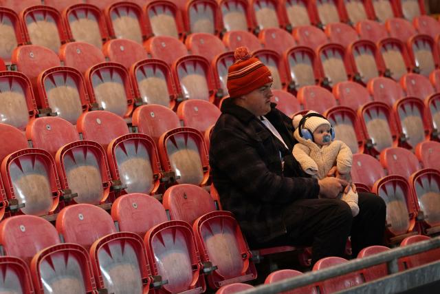 A fan and young fan await the kick off in the European Rugby Champions Cup pool 4 rugby union match between Scarlets and Section Paloise , Pau at Parc y Scarlets in Llanelli, south-west Wales on January 10, 2026. (Photo by Adrian Dennis / AFP)