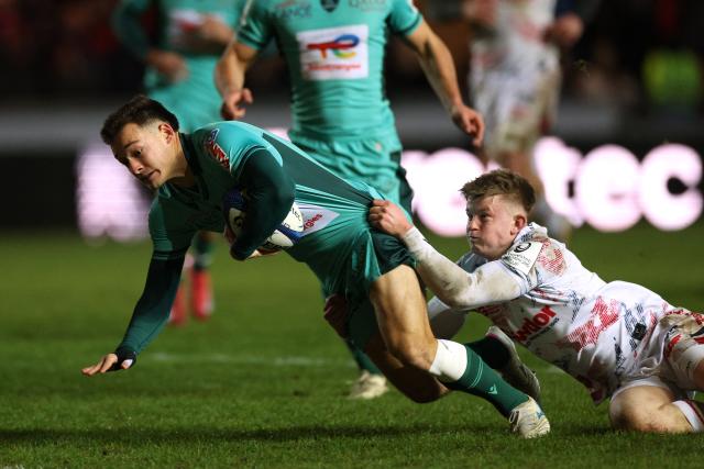 Pau's Clément Mondinat reaches for the line to score a try during the European Rugby Champions Cup pool 4 rugby union match between Scarlets and Section Paloise , Pau at Parc y Scarlets in Llanelli, south-west Wales on January 10, 2026. (Photo by Adrian Dennis / AFP)