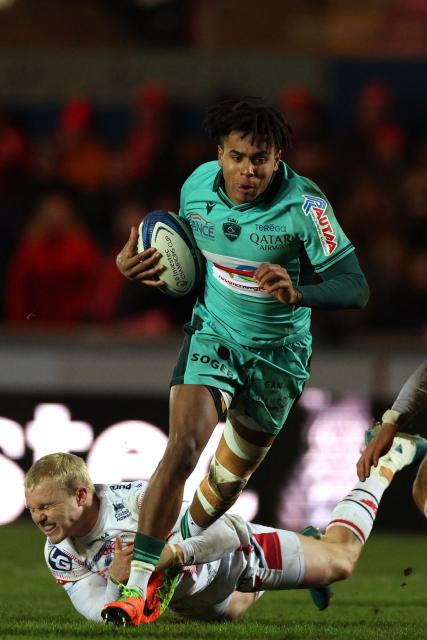 Pau's French full-back Théo Attissogbe makes a break during the European Rugby Champions Cup pool 4 rugby union match between Scarlets and Section Paloise , Pau at Parc y Scarlets in Llanelli, south-west Wales on January 10, 2026. (Photo by Adrian Dennis / AFP)