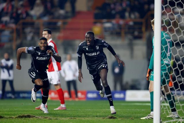 Vitoria Guimaraes's Senegalese forward # 90 Alioune Ndoye (R) celebrates scoring his team's second goal during the Portuguese Taca da Liga (League Cup) final football match between Vitoria SC and SC Braga at the Dr. Magalhaes Pessoa stadium in Leiria, on January 10, 2026. (Photo by FILIPE AMORIM / AFP)