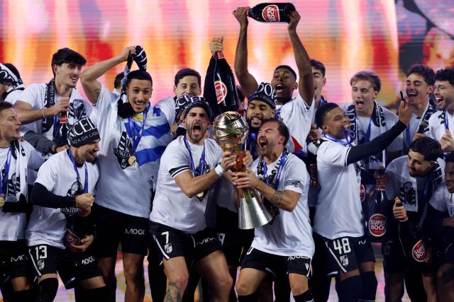 Vitoria Guimaraes's players celebrate with their trophy after winning the Portuguese Taca da Liga (League Cup) final football match between Vitoria SC and SC Braga at the Dr. Magalhaes Pessoa stadium in Leiria, on January 10, 2026. Vitoria Guimaraes won the finale 2-1. (Photo by FILIPE AMORIM / AFP)